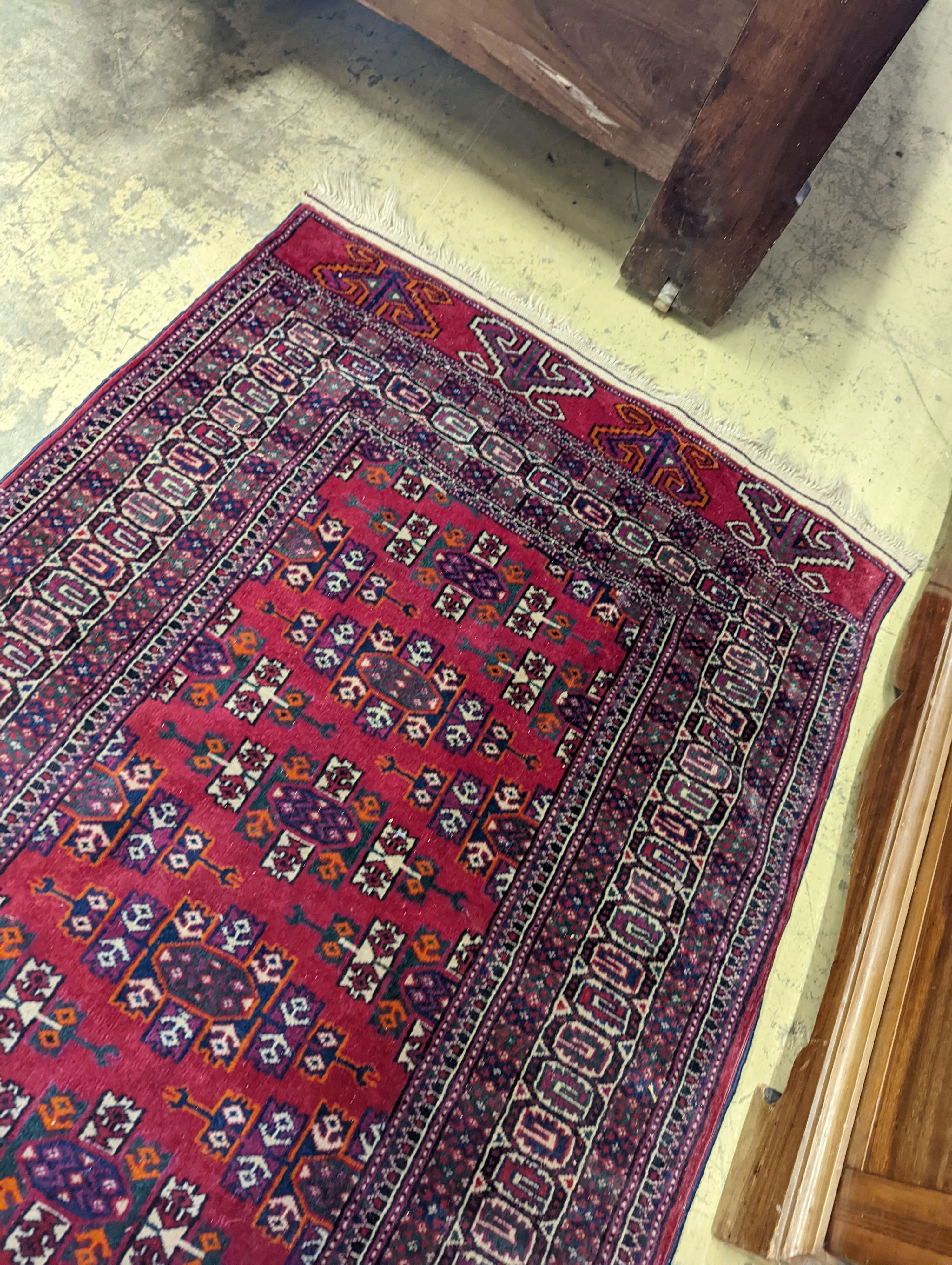 A Bokhara burgundy ground runner, 276 x 88cm